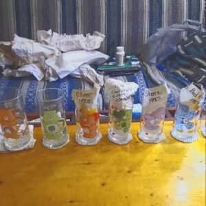 Collectable "Care Bears" different size glasses and characters.